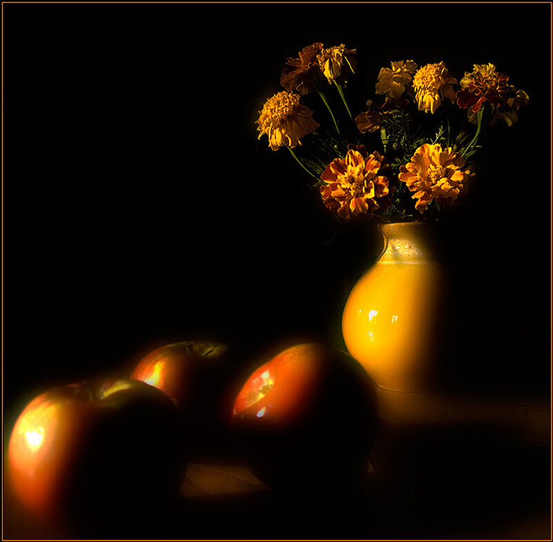 Apples and marigolds in dim light