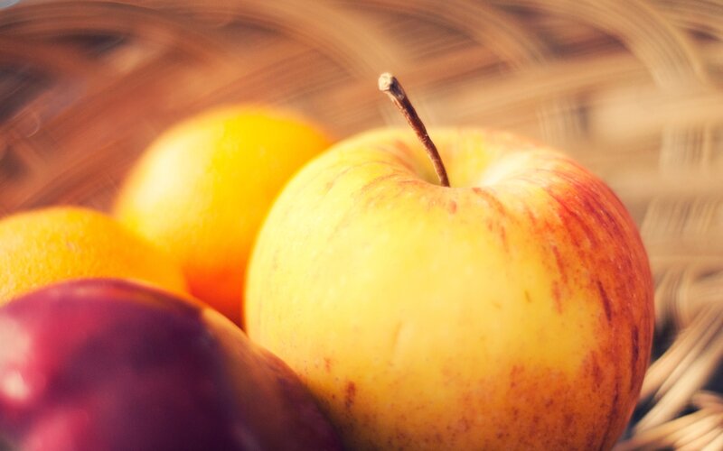 apples and oranges in a basket