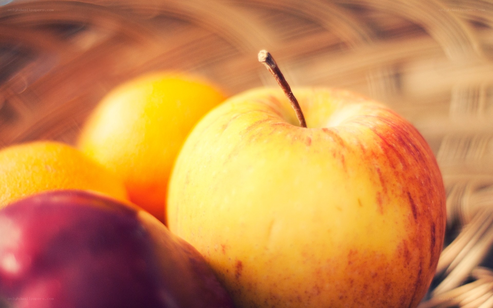 apples and oranges in a basket