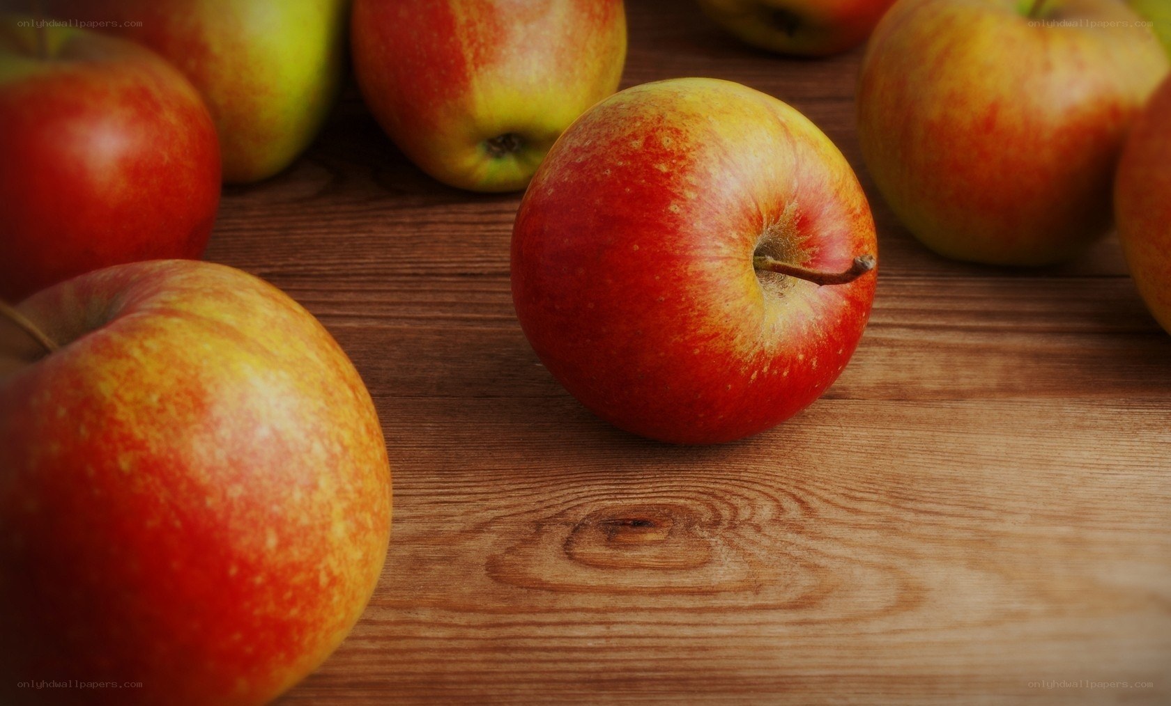 apples on wooden surface