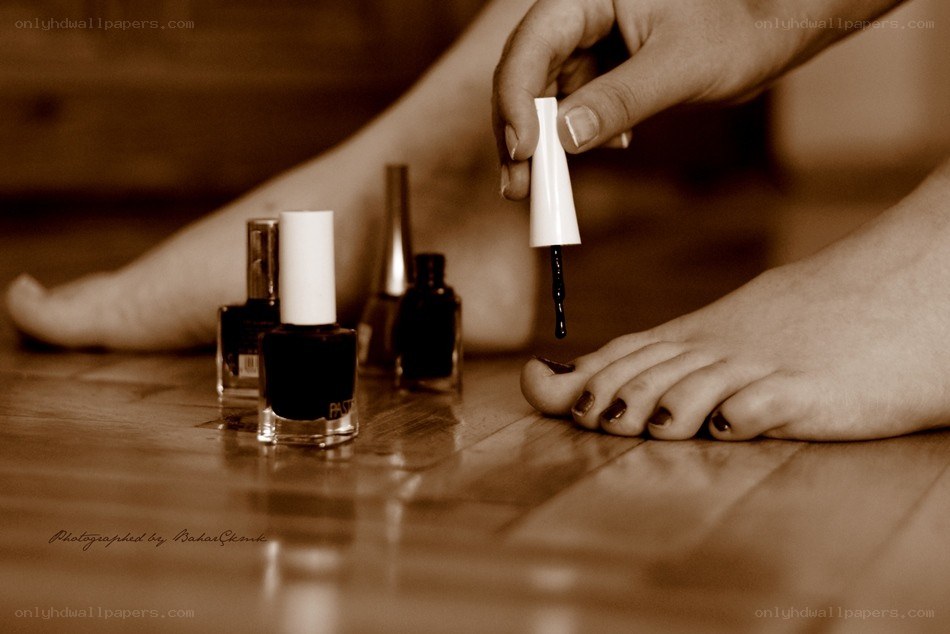 applying nail polish to feet