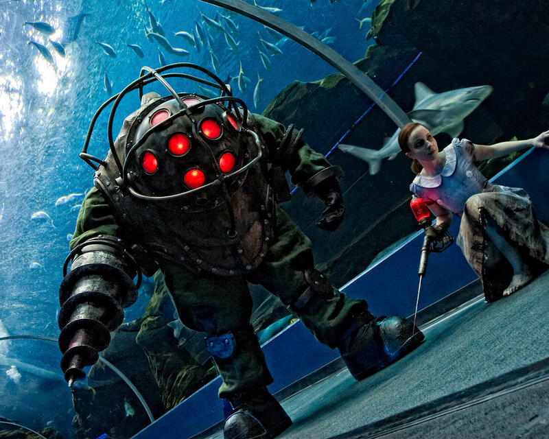 Aquarium scene with diver and girl