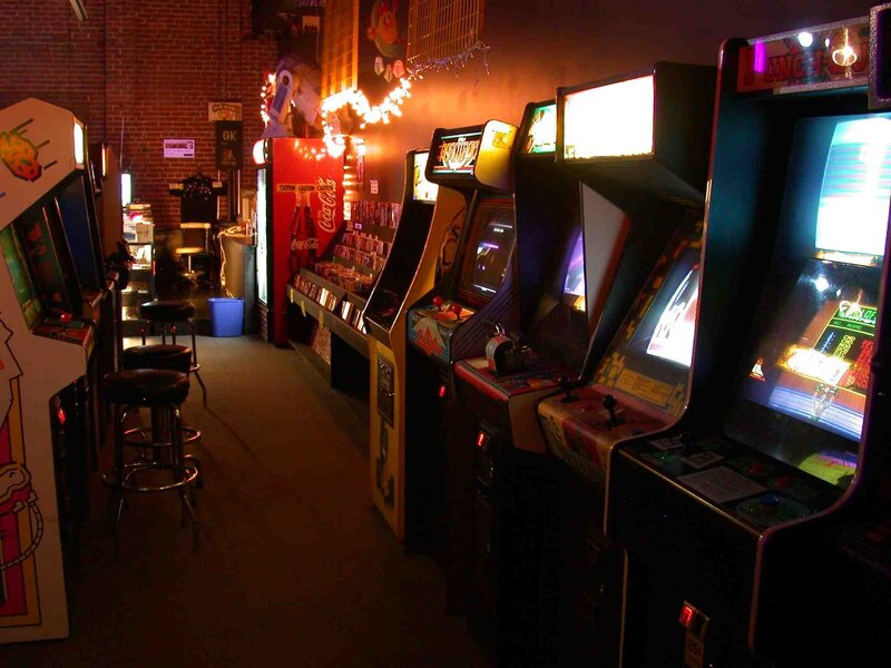arcade game machines in a dimly lit room