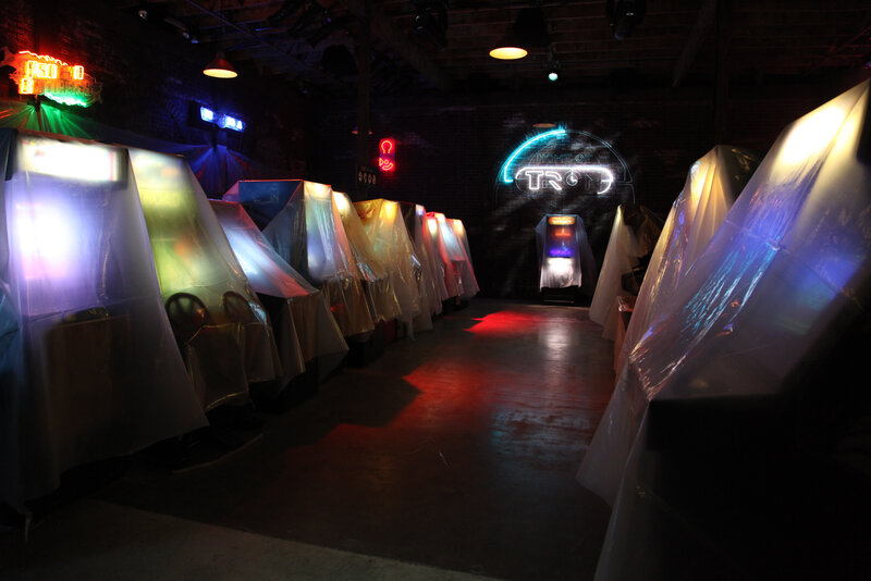 arcade game room with neon signs