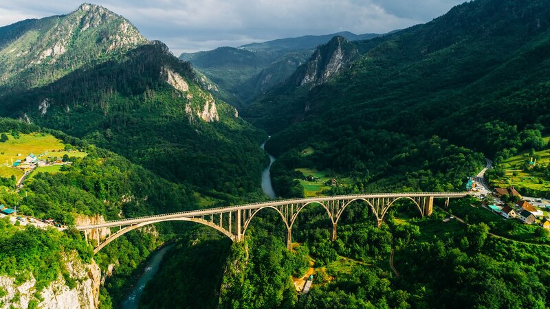 Arch Bridge over River — Green, Serene, Afternoon