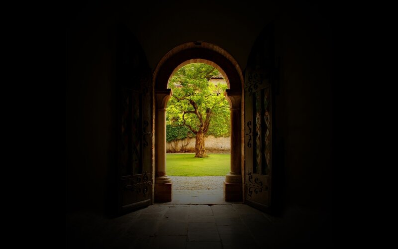 archway to a sunlit garden