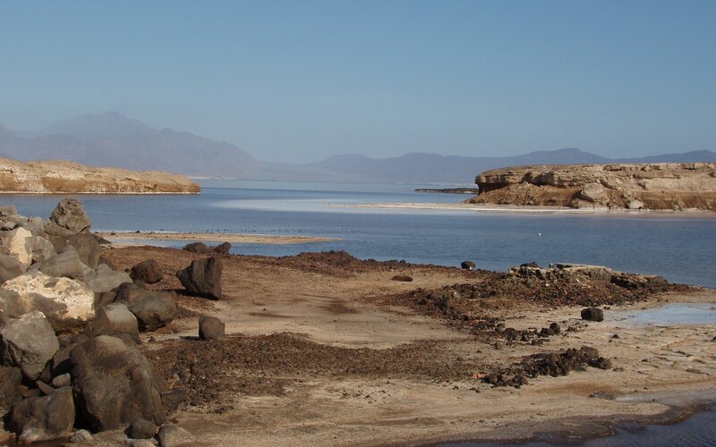 arid lake with rocky shore