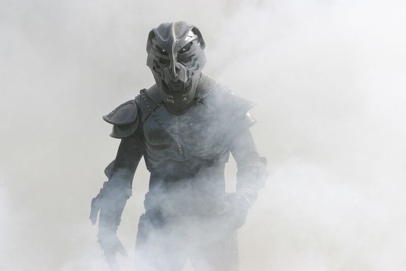 armored figure in smoke