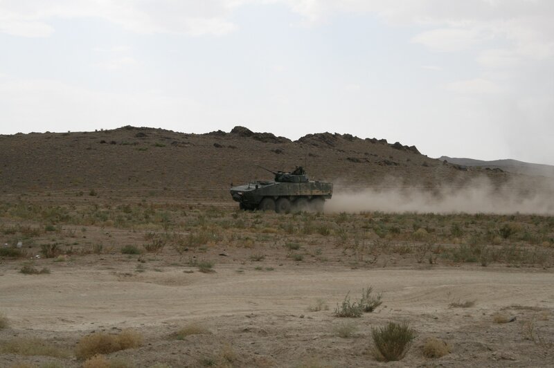 Armored Vehicle in Desert — Brown, Arid, Afternoon, Photograph