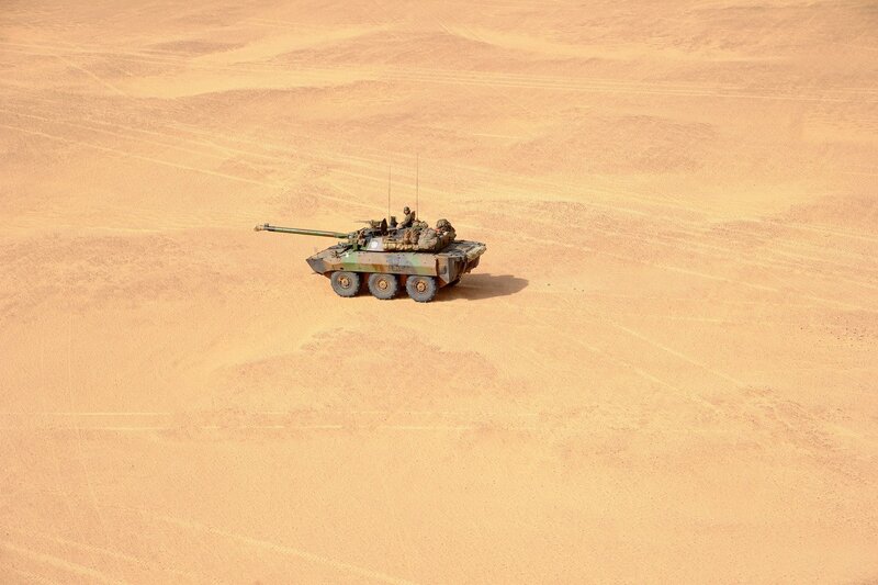 Armored Vehicle in Desert — Brown, Desolate, Afternoon, Photograph