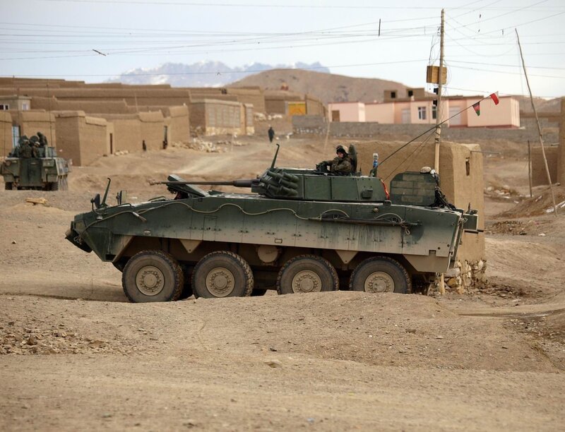 Armored Vehicle in Desert — Green, Dusty, Afternoon
