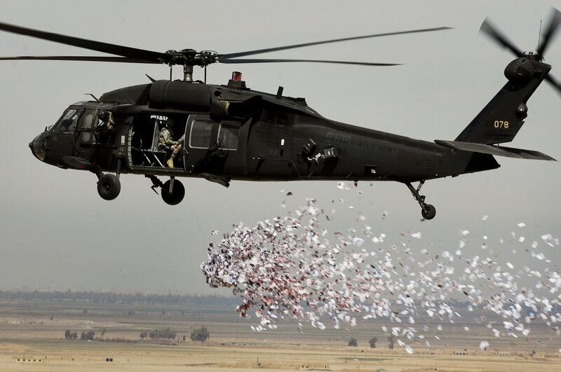 Army helicopter dropping leaflets