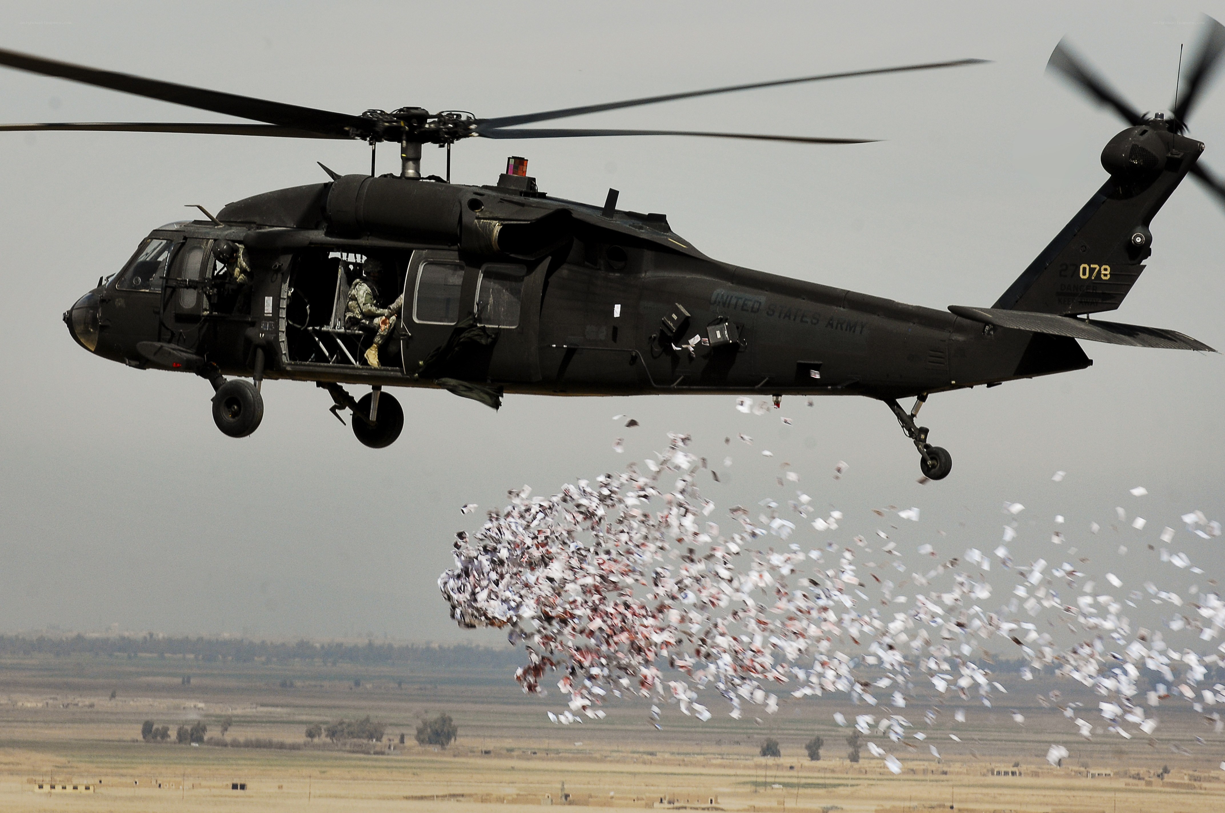 Army helicopter dropping leaflets