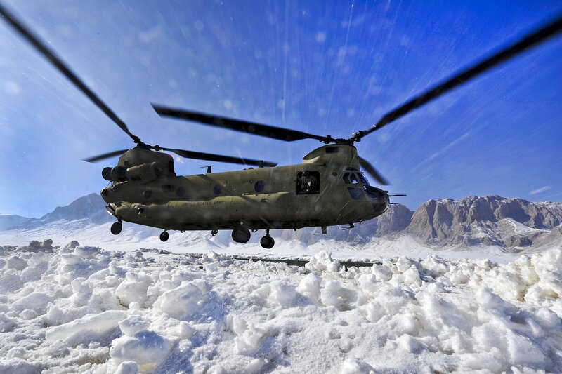 Army helicopter in snowy mountains