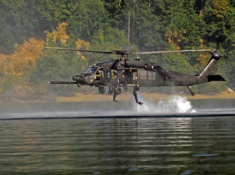 Army helicopter landing on water
