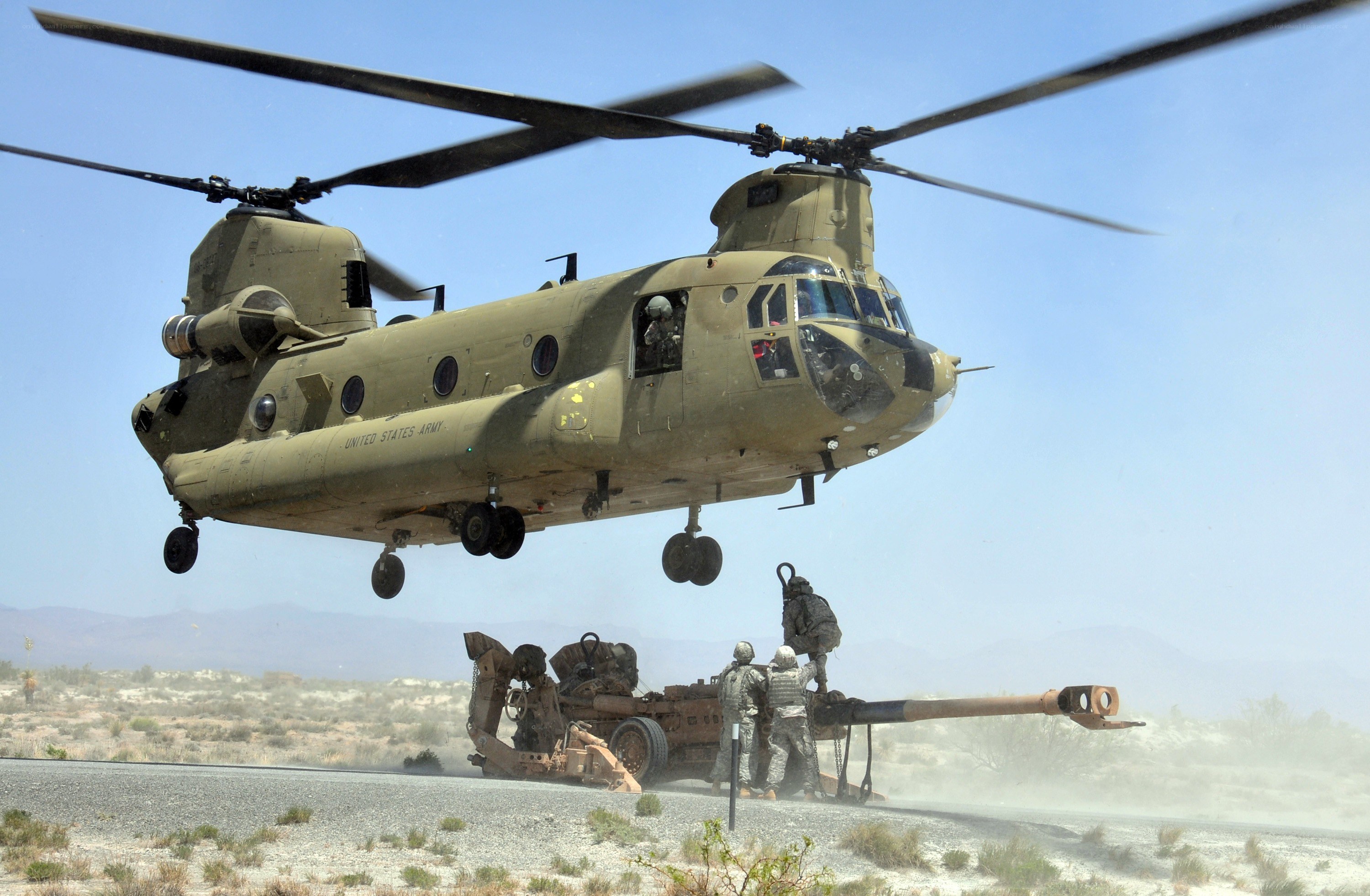 Army helicopter lifting artillery