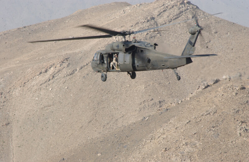 Army helicopter over mountain
