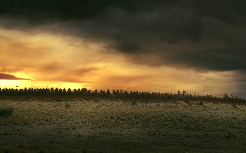 army on a battlefield at sunset