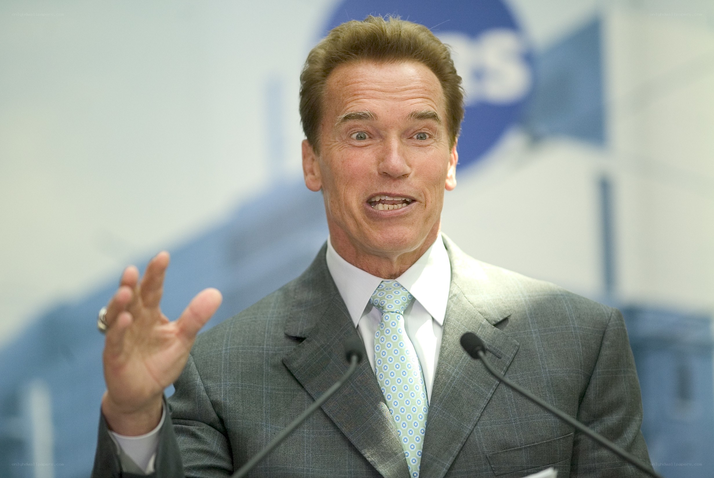 Arnold Schwarzenegger speaking at podium