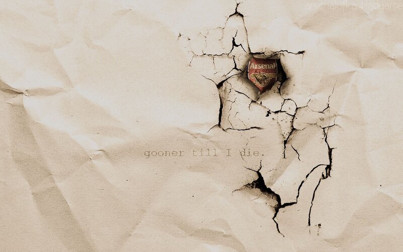 Arsenal FC logo through cracked paper