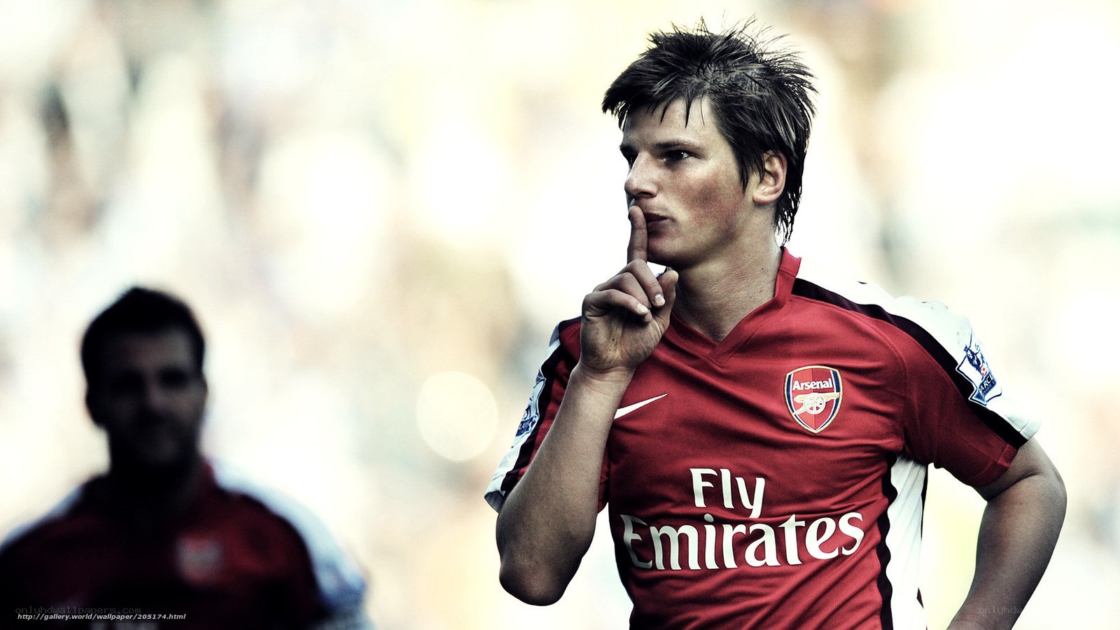 Arsenal football player in red jersey