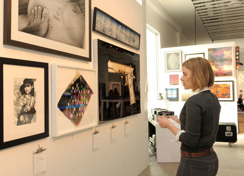 Art gallery visitor viewing artwork