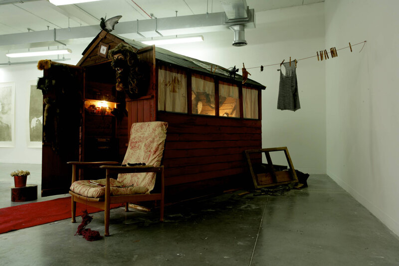Art installation with shed and chair