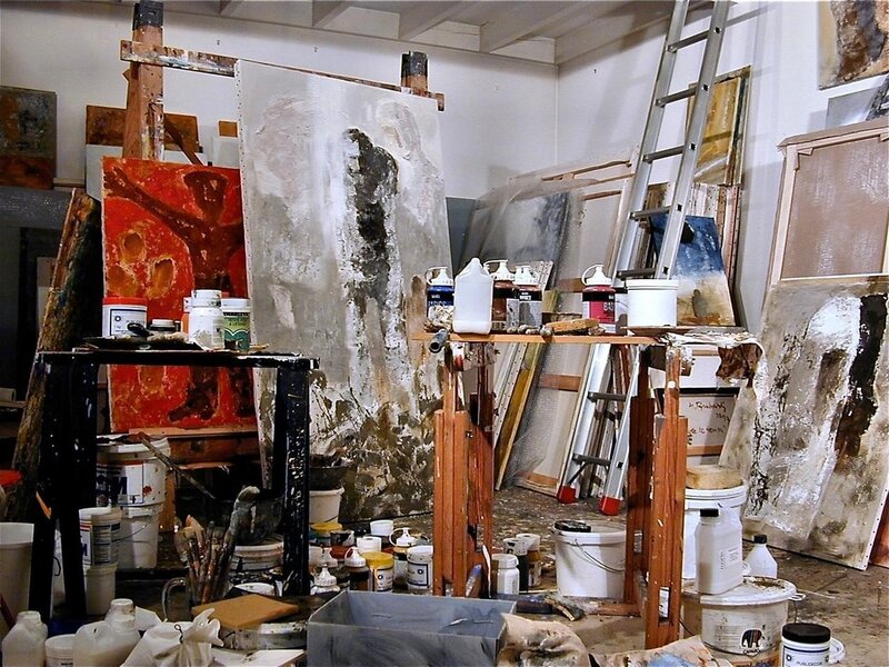 art studio with paintings and supplies