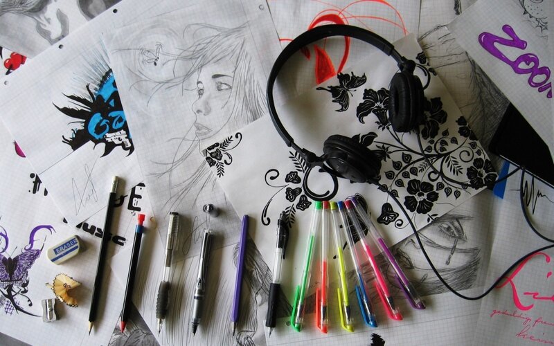 art supplies and sketches on desk