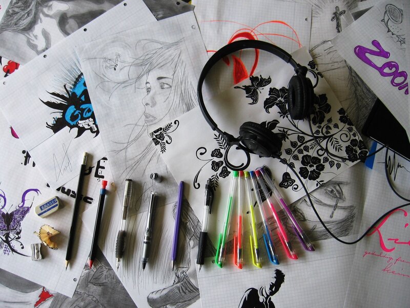 Art supplies and sketches on paper