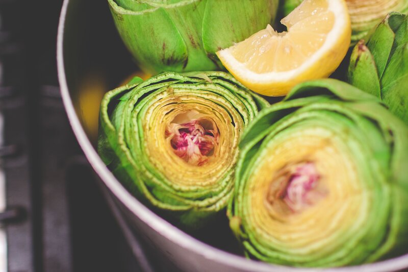 Artichokes with lemon in a pot