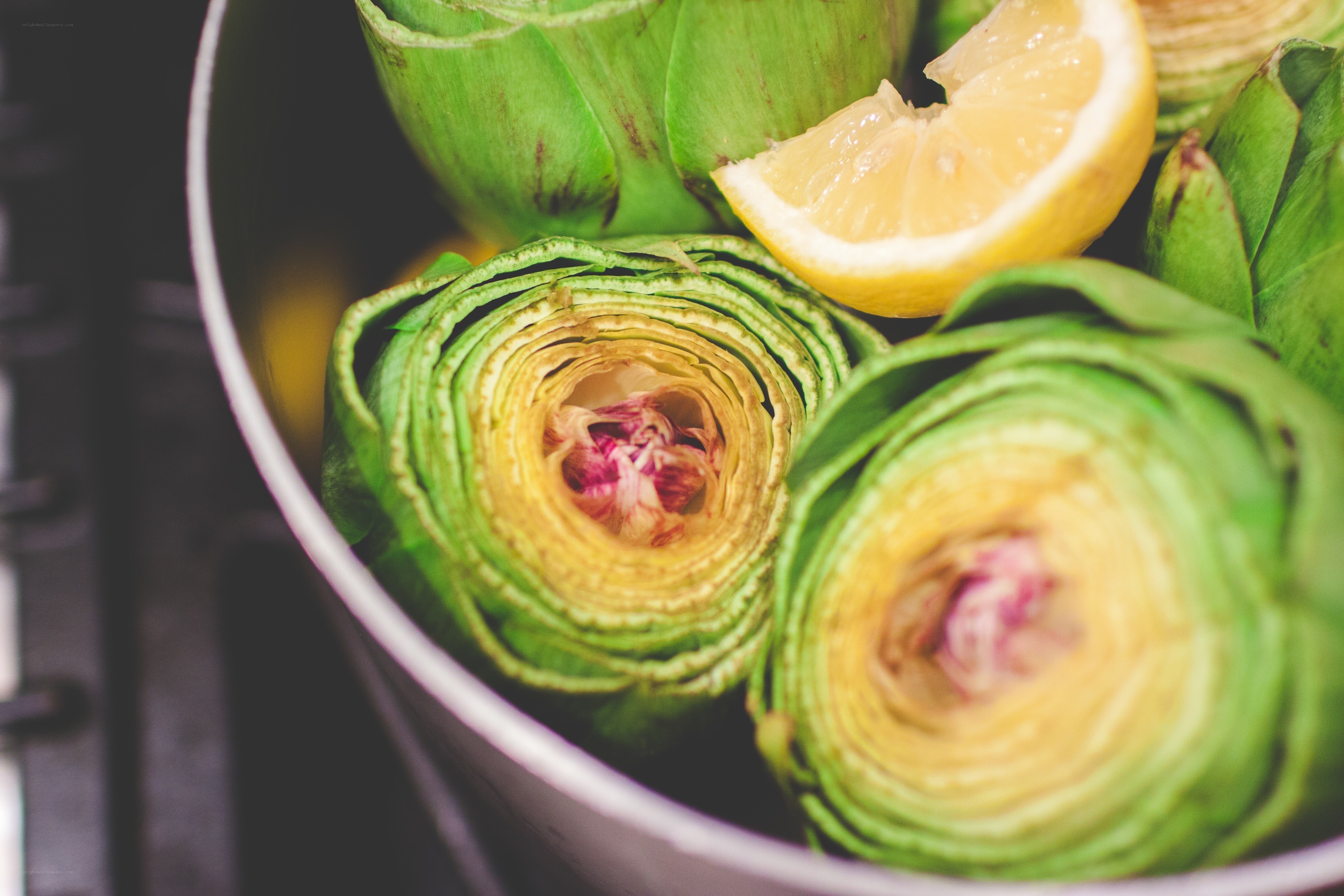 Artichokes with lemon in a pot