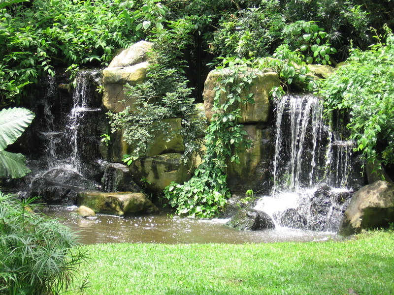 Artificial Waterfall in Garden — Green, Serene, Afternoon, Photograph, Rocks