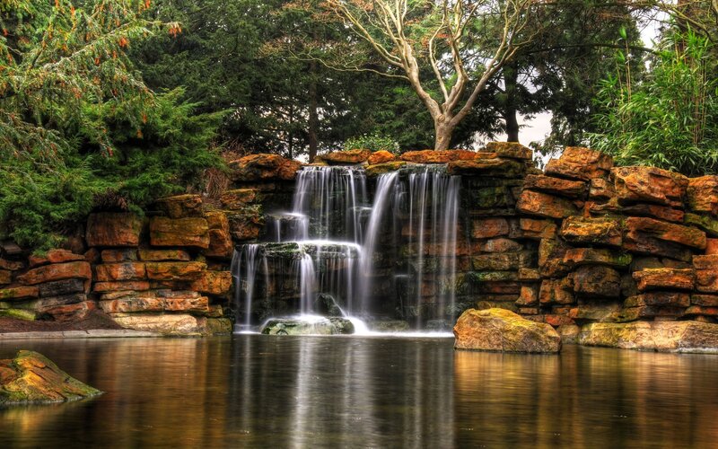 Artificial Waterfall in Garden — Green, Serene, Afternoon, Photograph, Rocks, Trees, Pond