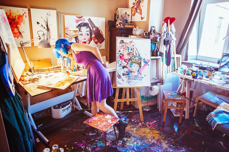 Artist at work in a colorful studio