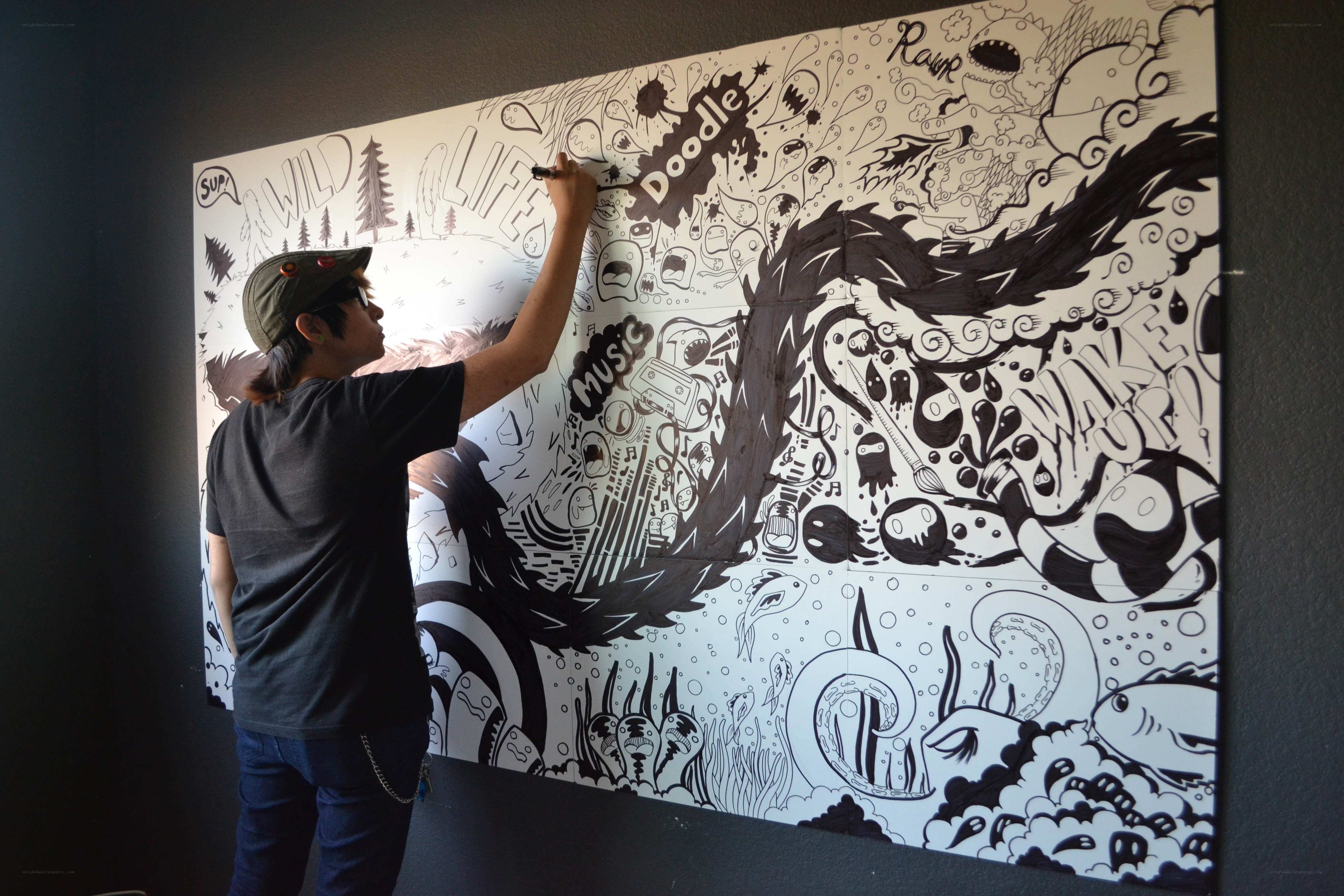Artist drawing a large mural