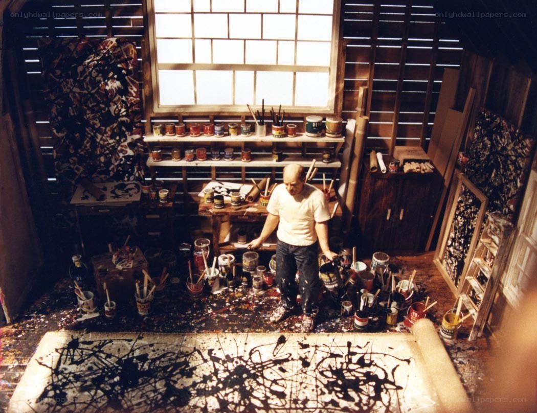 Artist in a paint-splattered studio