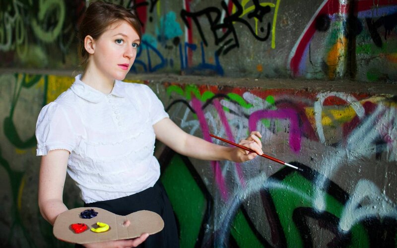 artist painting graffiti wall