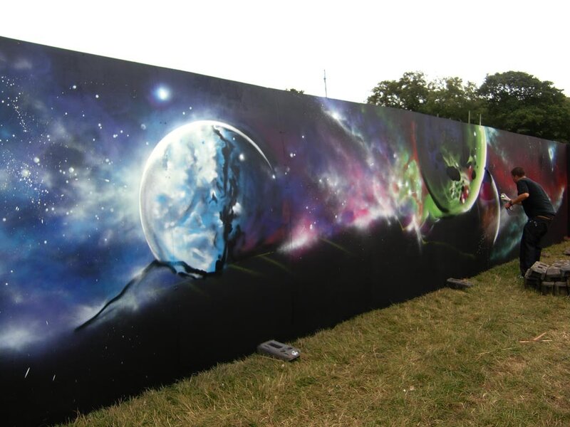 Artist painting space mural