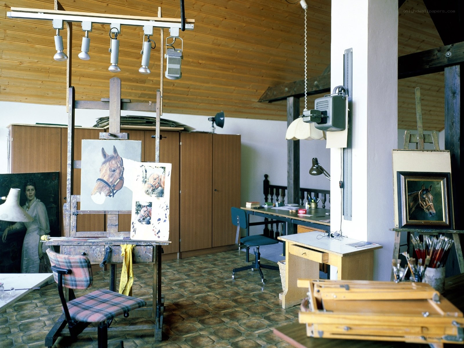 artist's studio with horse paintings