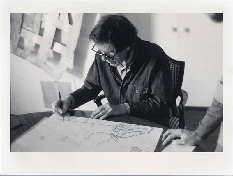 Artist sketching at a table