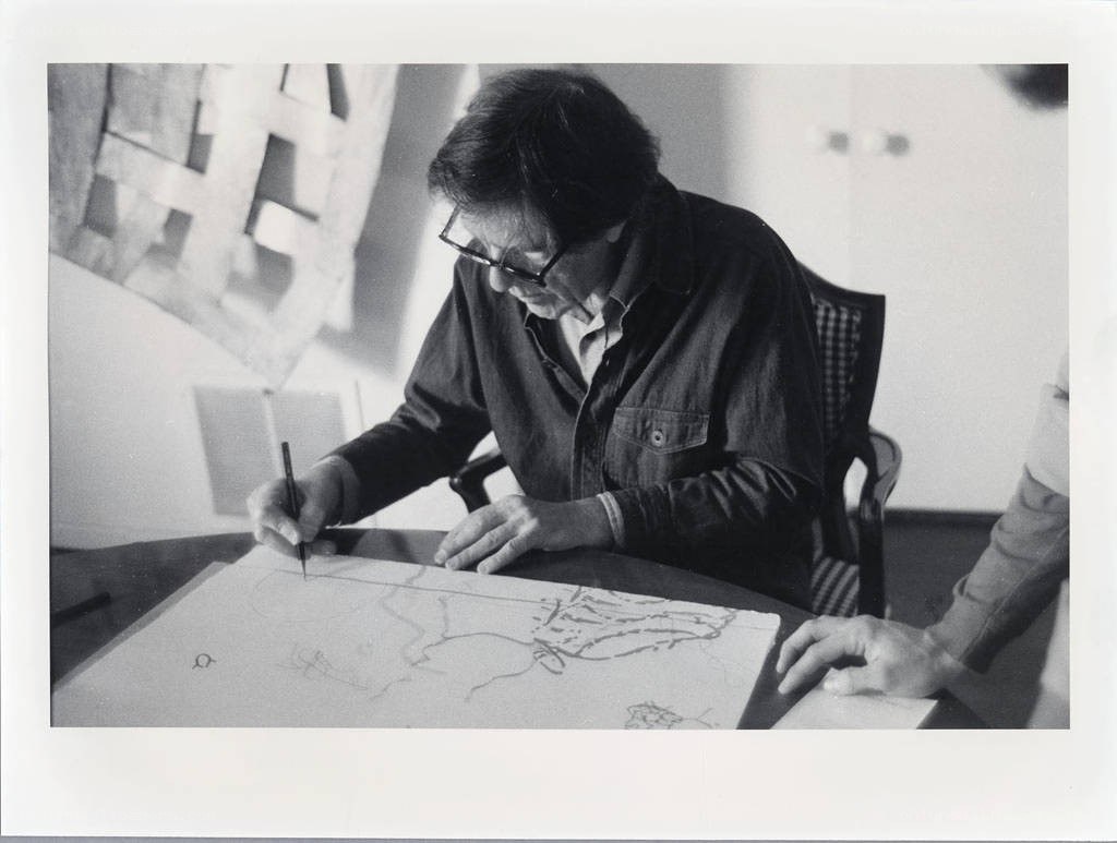 Artist sketching at a table