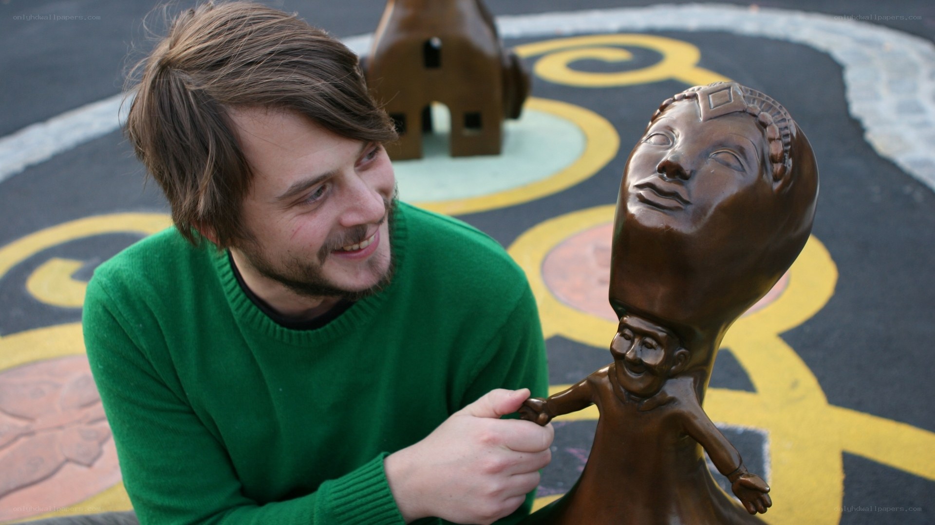 Artist with bronze sculpture