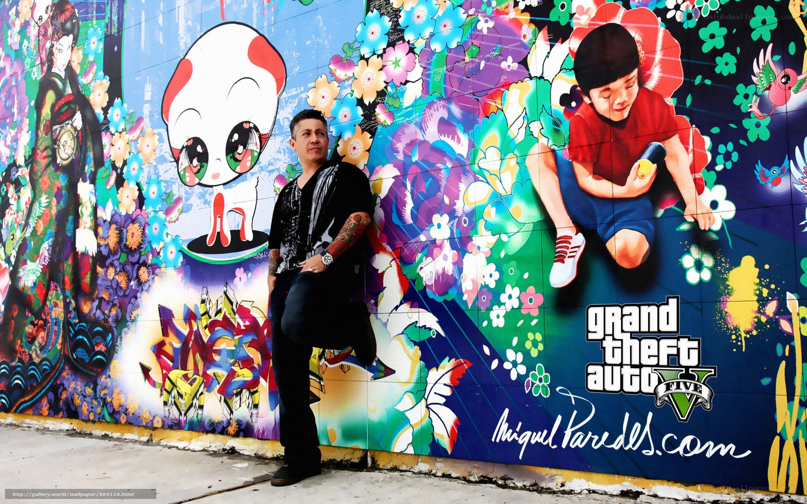 Artist with graffiti mural