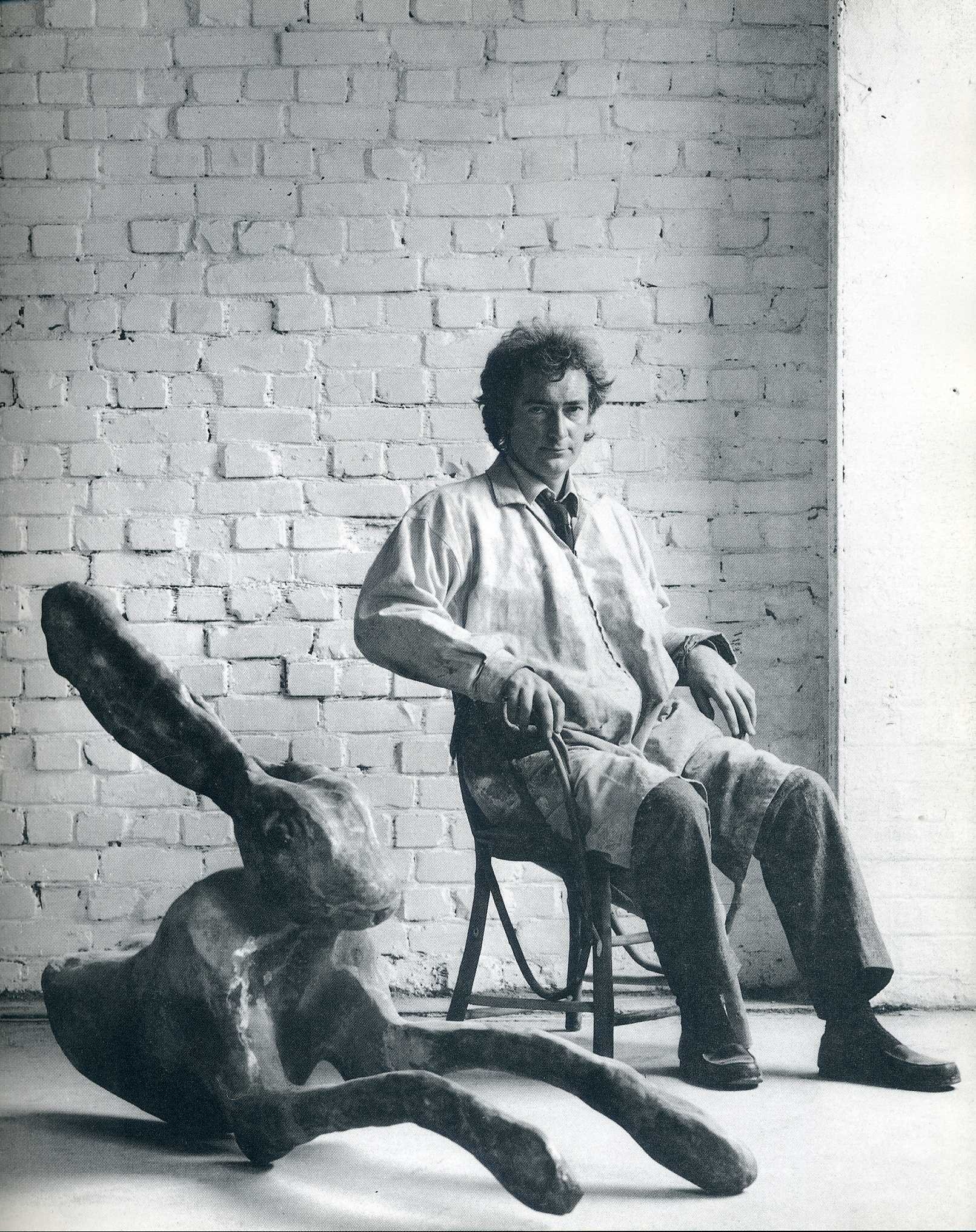artist with sculpture in studio