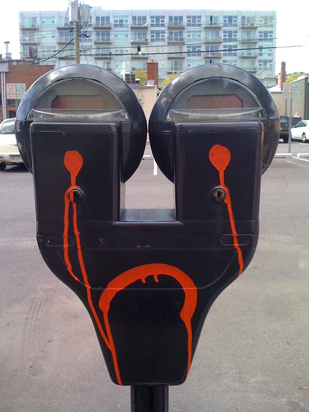 Artistic parking meter with orange paint
