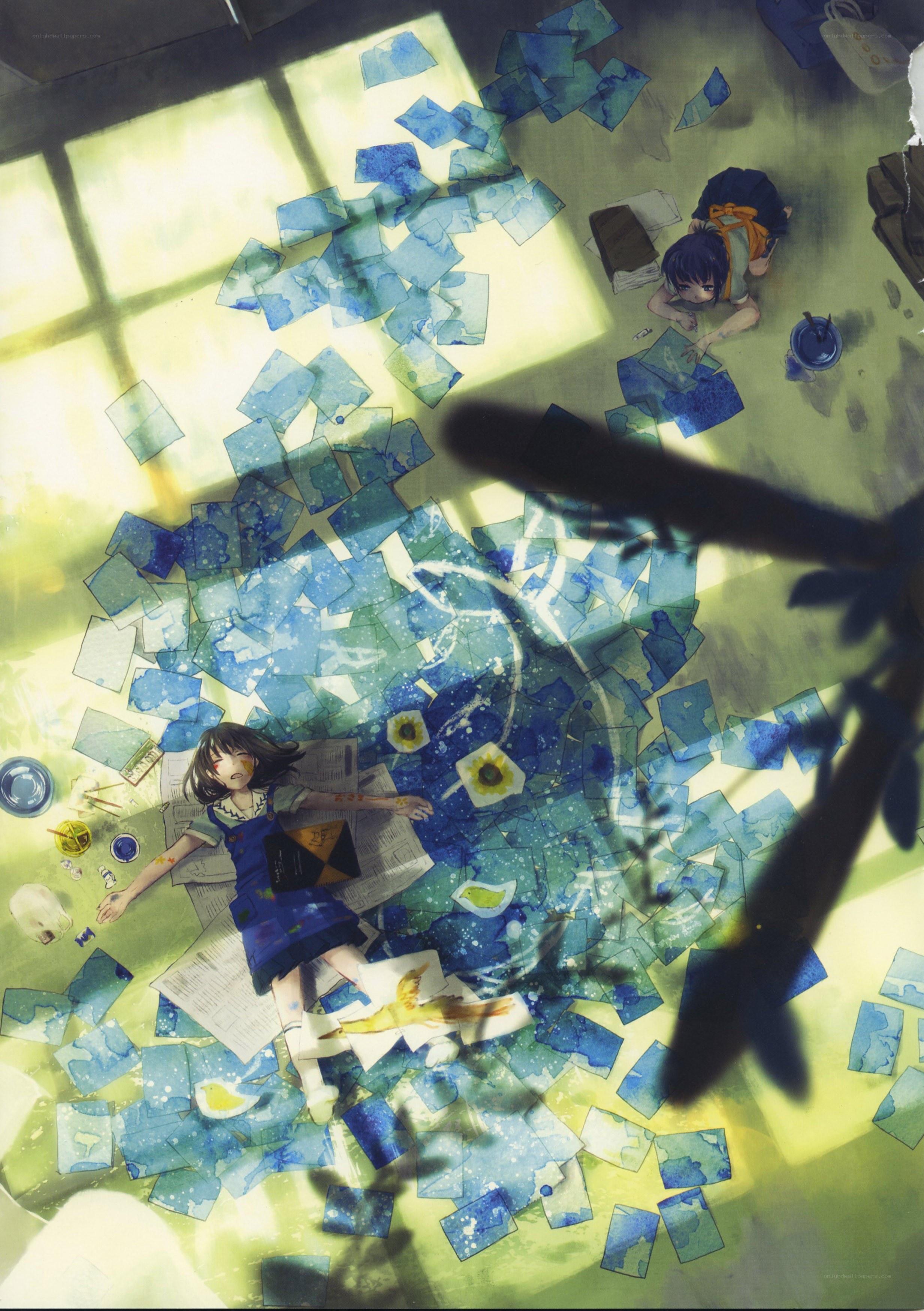 Artists at work in a sunlit room