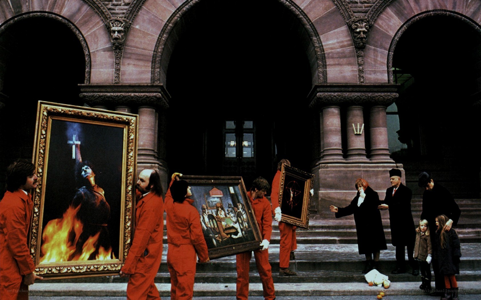 Artists carrying paintings outside building