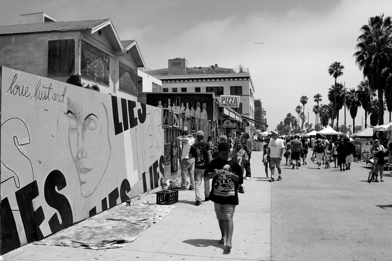 Artists painting on a boardwalk