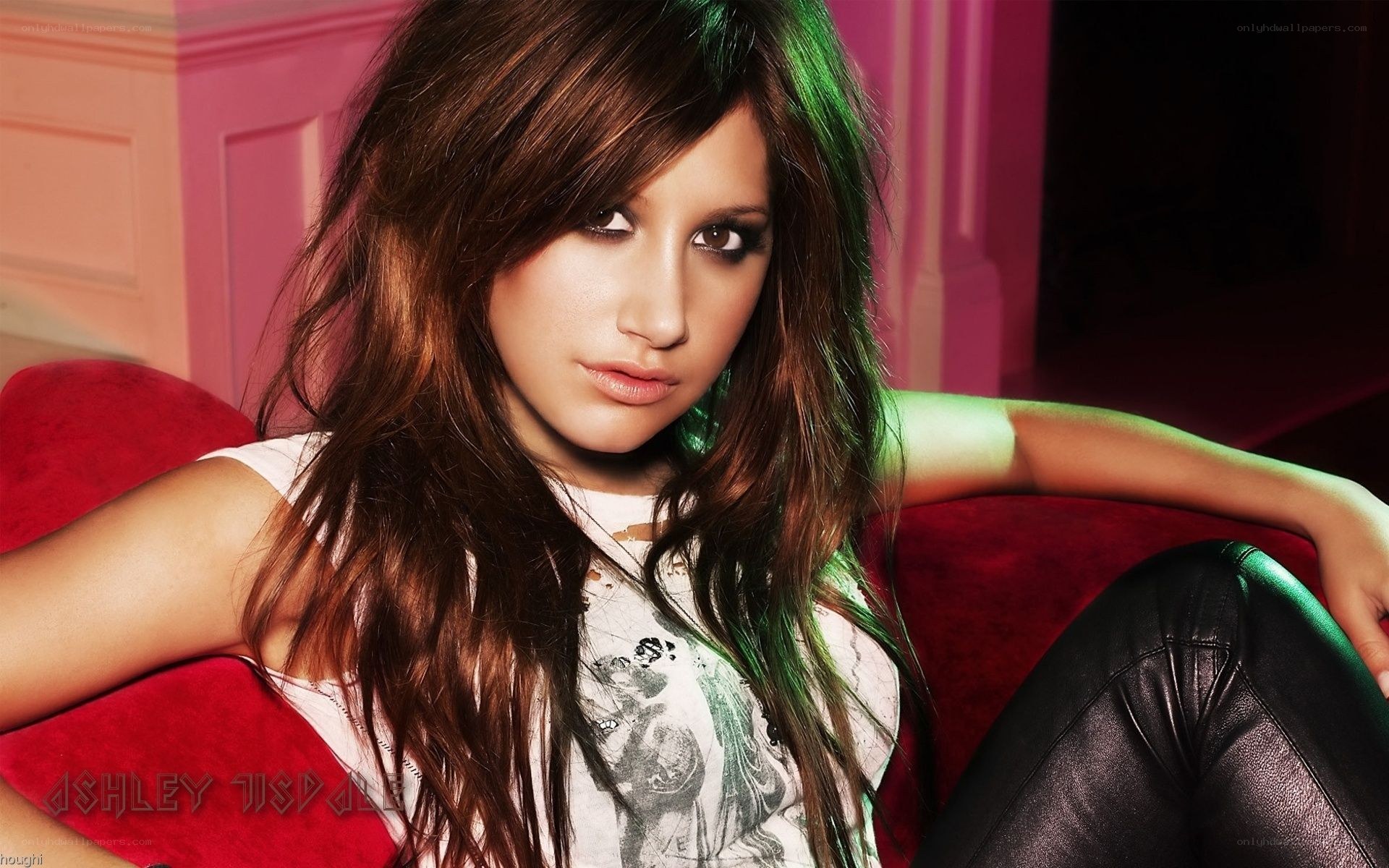 Ashley Tisdale on a red couch